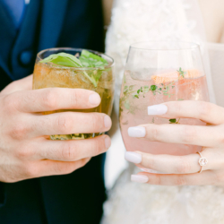 wedding couple with cocktails in hand
