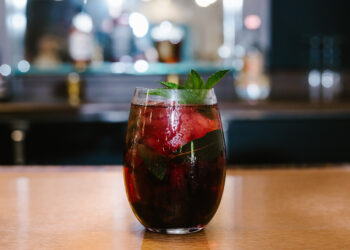 bar with red cocktail in glass