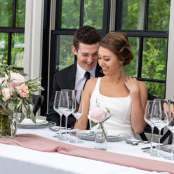 couple sitting at head table at south haven creations venue