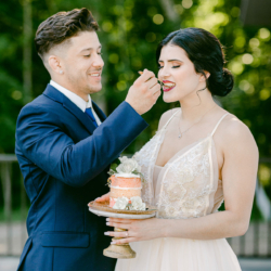 wedding couple eating cake on venue deck