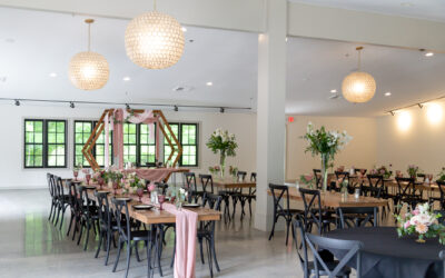 banquet room set up with walnut tables and mauve decor