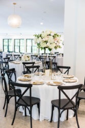 reception room set up with white table linens and gold chargers
