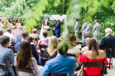 wedding ceremony peeking throught the trees