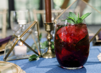 glass of red cocktail on blue linen wedding table