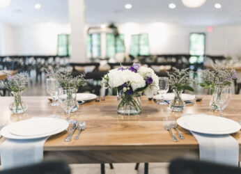 wood table with glass vases and flowers